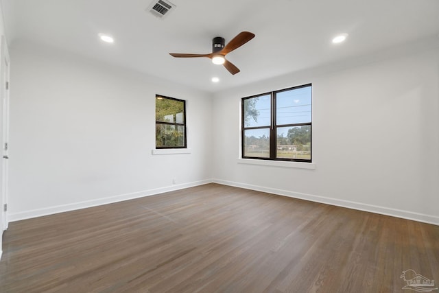 spare room with ceiling fan and dark wood-type flooring