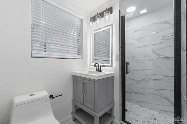 bathroom featuring a marble finish shower, toilet, and vanity