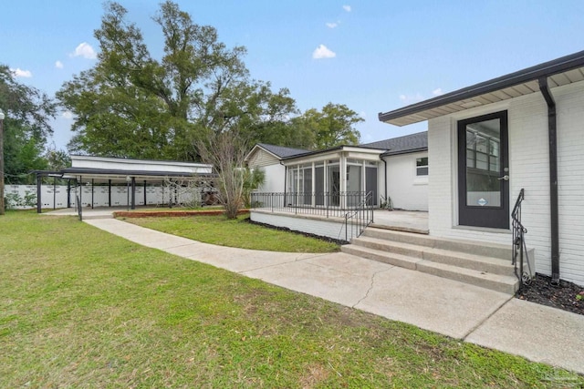 view of yard with entry steps and a sunroom