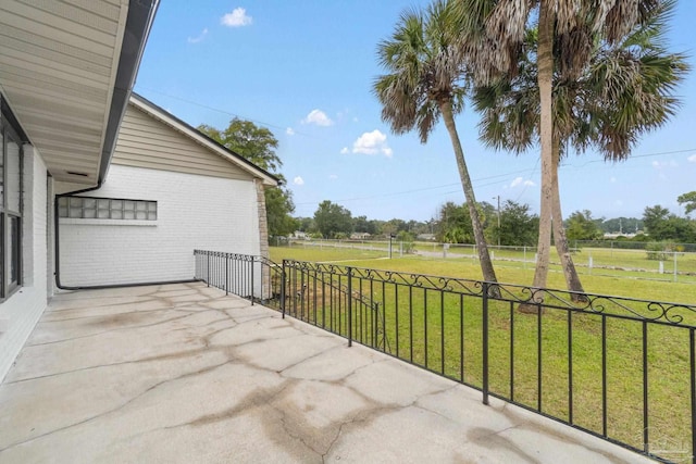 view of patio with a rural view and fence