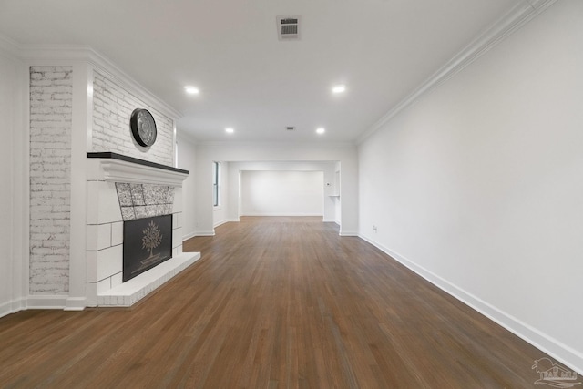 unfurnished living room with visible vents, baseboards, dark wood finished floors, a fireplace, and crown molding