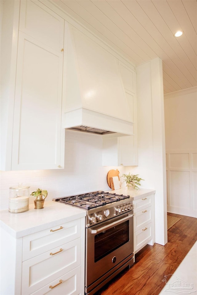 kitchen featuring crown molding, custom range hood, white cabinets, and high end stove