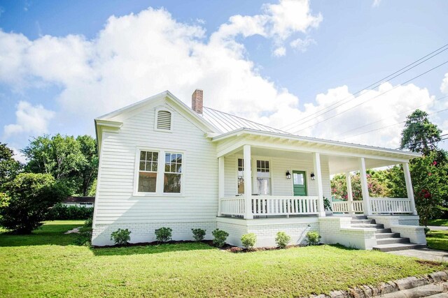 spare room featuring decorative columns, a wealth of natural light, crown molding, and hardwood / wood-style floors