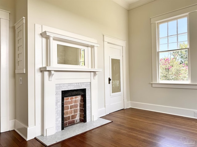 1524 E Strong St, Pensacola, FL 32501 - unfurnished living room featuring wood finished floors, plenty of natural light, baseboards, crown molding, and a fireplace