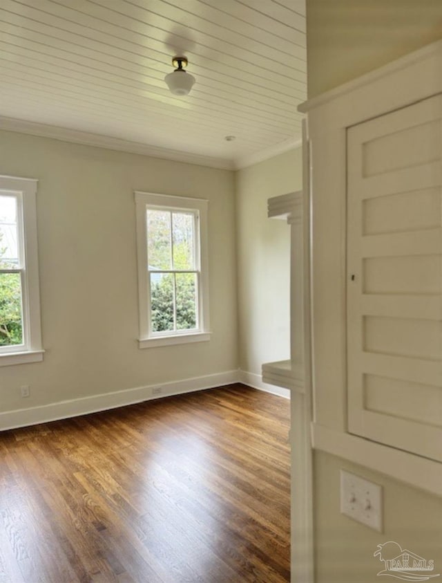 1524 E Strong St, Pensacola, FL 32501 - spare room featuring crown molding, dark wood-type flooring, and baseboards