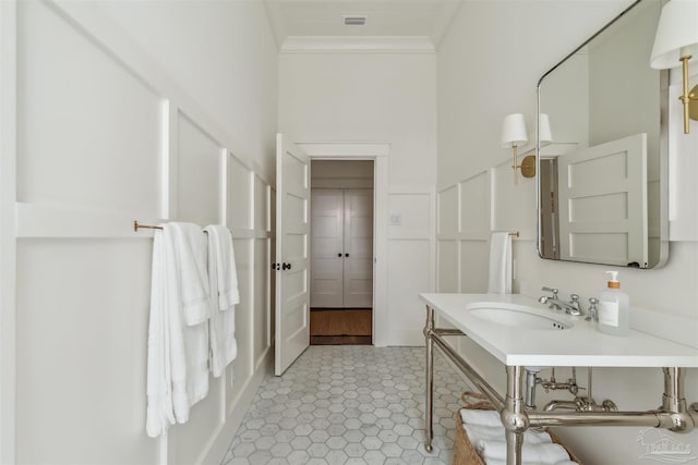 1524 E Strong St, Pensacola, FL 32501 - bathroom with crown molding, tile patterned flooring, and vanity