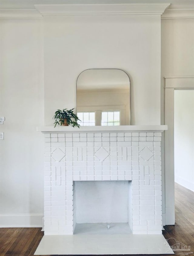 interior details with hardwood / wood-style flooring, ornamental molding, and a fireplace