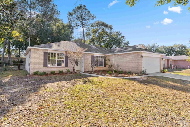 ranch-style house with a garage and a front lawn