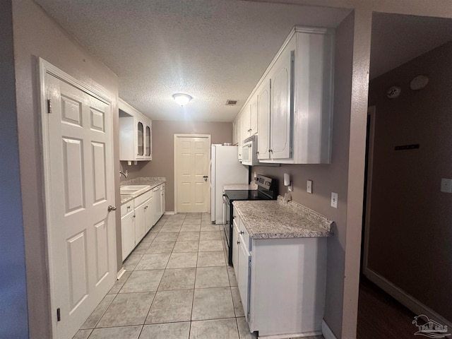 kitchen with stainless steel electric stove, light countertops, a textured ceiling, white cabinetry, and a sink