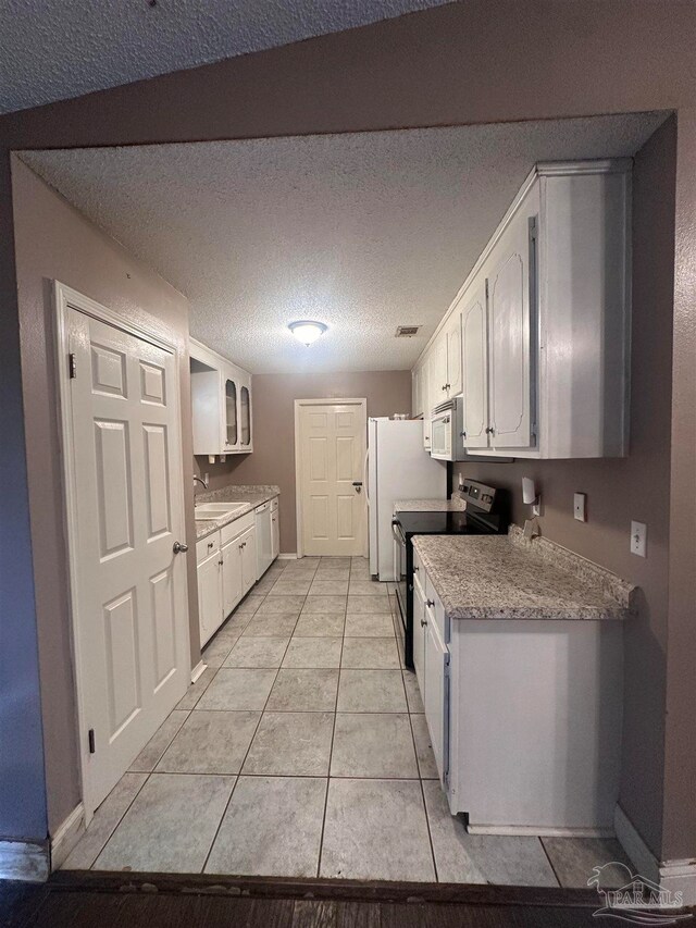 full bath with a textured ceiling, bathtub / shower combination, toilet, wood walls, and vanity