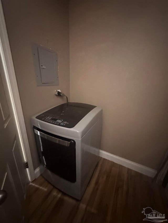 laundry area featuring electric panel, washer / dryer, wood finished floors, and laundry area