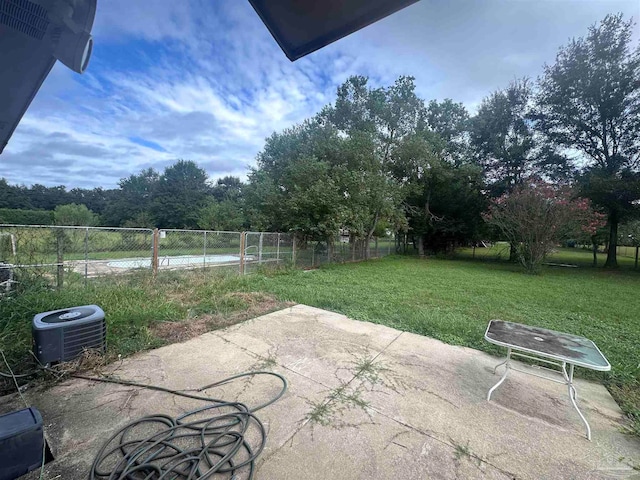 view of yard featuring cooling unit, a patio, and fence