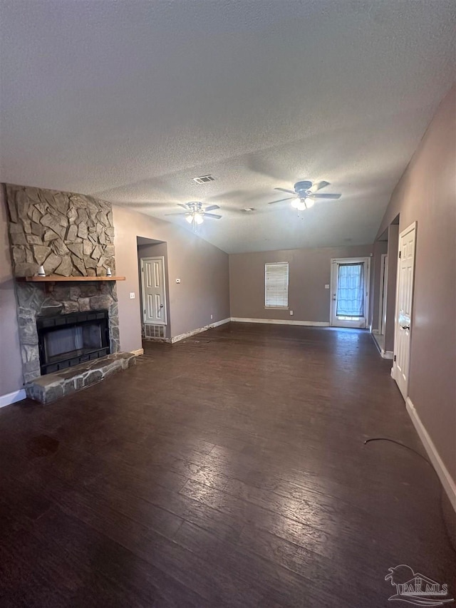 unfurnished living room with a fireplace, wood finished floors, a ceiling fan, and a textured ceiling