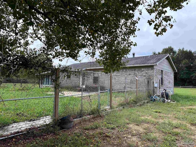 view of side of home featuring fence