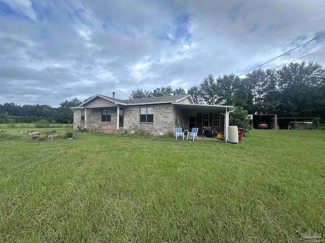 rear view of house with a carport and a lawn