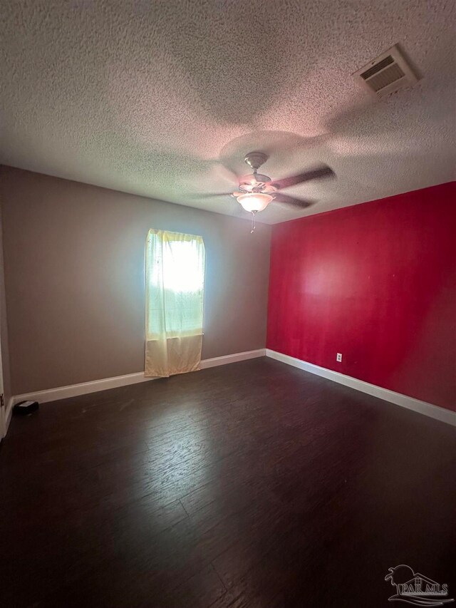 laundry room with electric water heater, laundry area, wood finished floors, visible vents, and washer / dryer