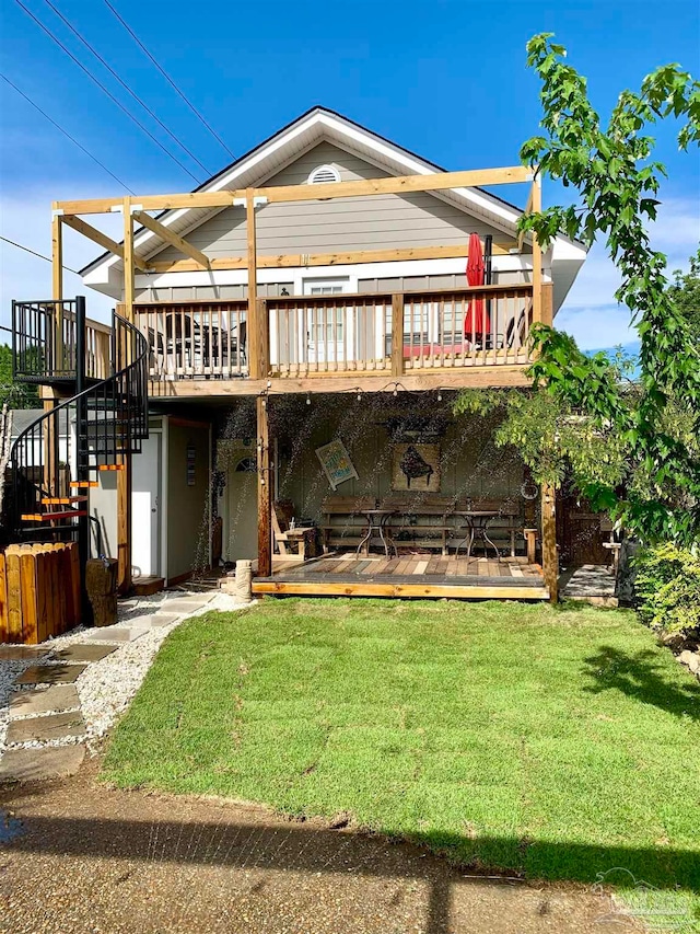 back of house featuring a wooden deck and a yard