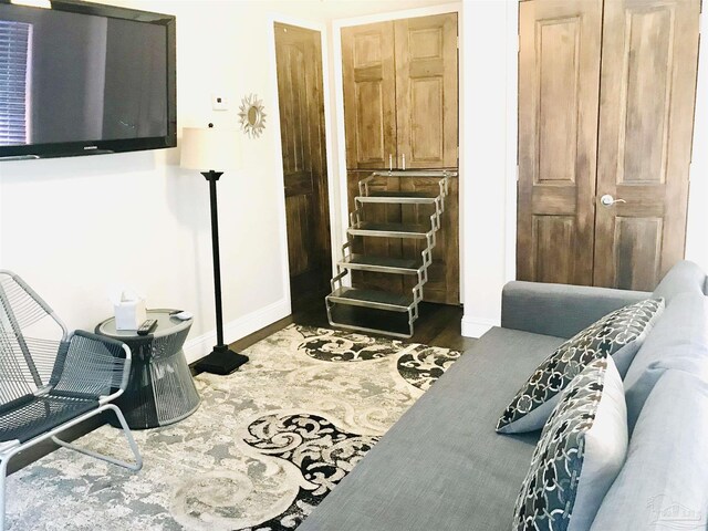 bedroom with dark wood-type flooring