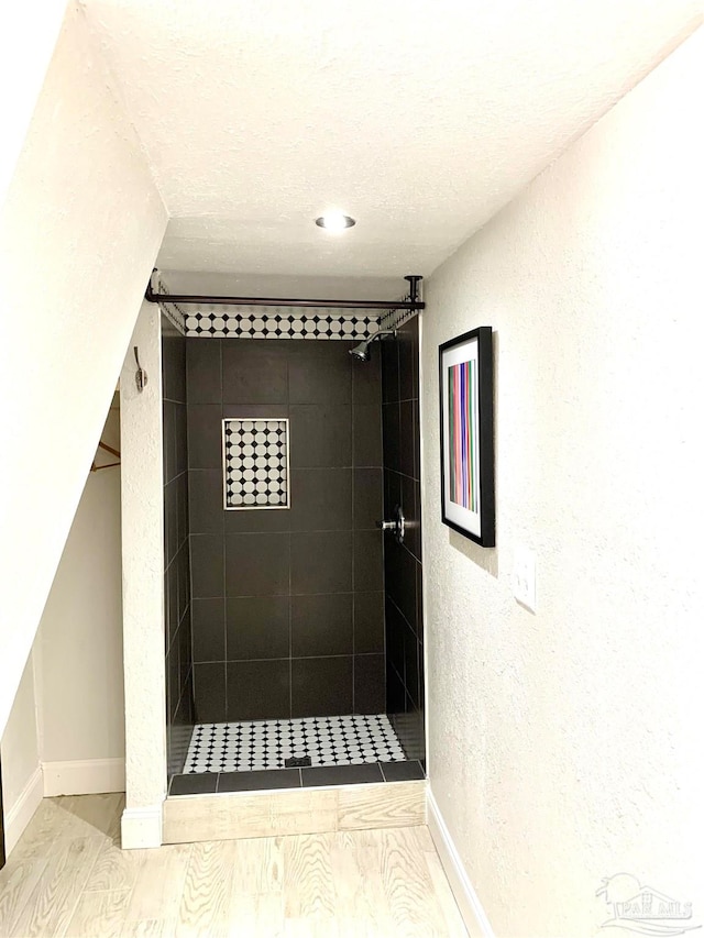 interior space featuring wood-type flooring and a textured ceiling