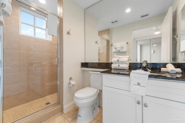 bathroom with toilet, vanity, tile patterned floors, and an enclosed shower