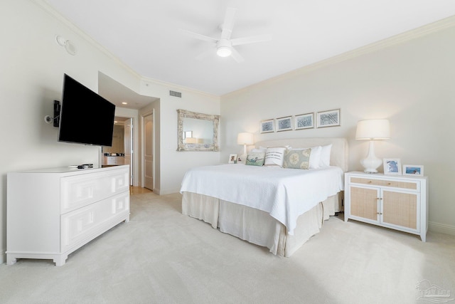 carpeted bedroom with ceiling fan and crown molding