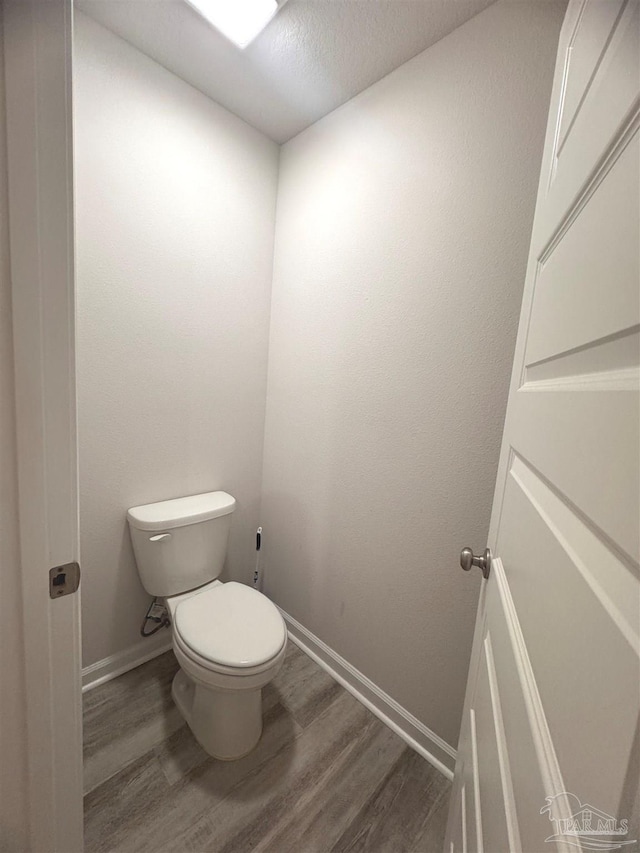 3468 Fallschase Blvd, Pensacola, FL 32526 - bathroom with wood finished floors, baseboards, toilet, and a textured ceiling