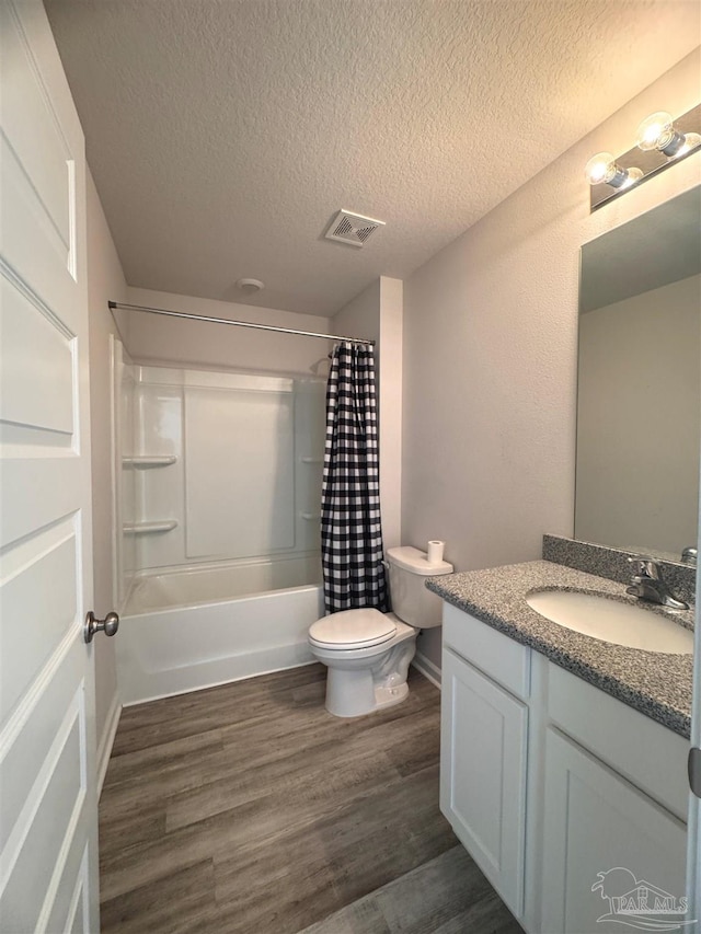 3468 Fallschase Blvd, Pensacola, FL 32526 - full bath with toilet, vanity, a textured ceiling, shower / bath combo, and wood finished floors
