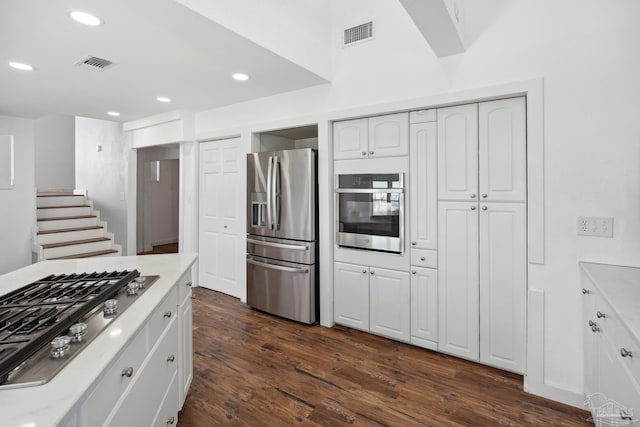 kitchen with white cabinetry, dark wood-type flooring, and appliances with stainless steel finishes