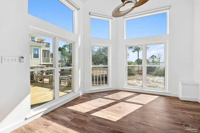 unfurnished sunroom featuring plenty of natural light and ceiling fan