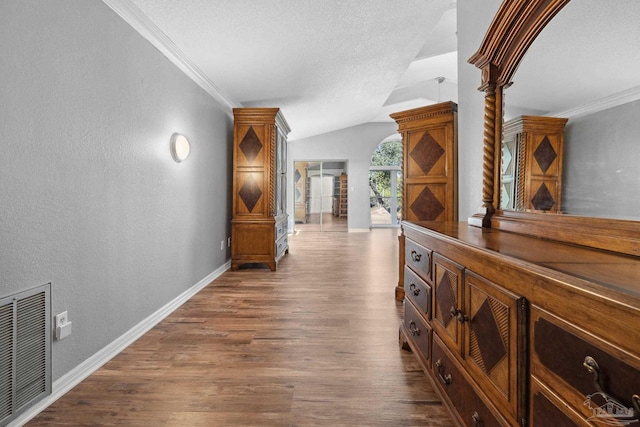 corridor featuring ornamental molding, lofted ceiling, and dark wood-type flooring