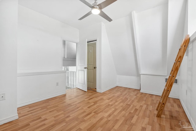 unfurnished bedroom with light hardwood / wood-style flooring, ceiling fan, and lofted ceiling