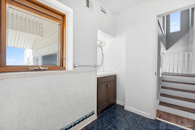 bathroom with tile patterned floors and vanity