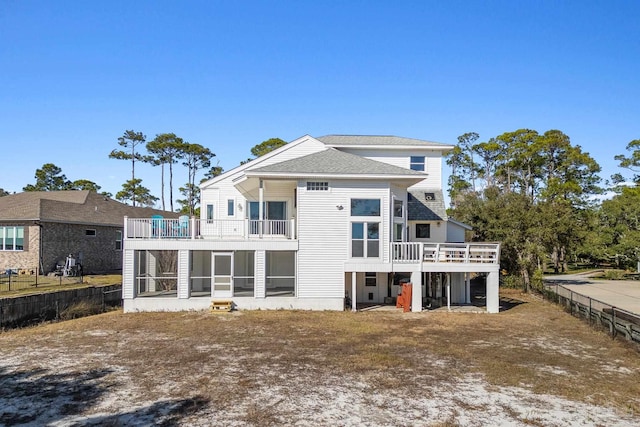 back of house featuring a sunroom