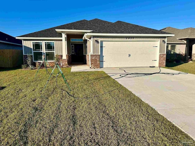 view of front of house with a garage and a front yard