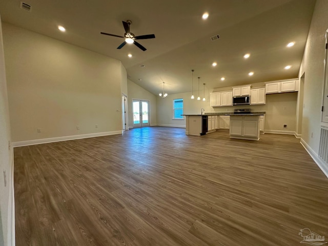 unfurnished living room with ceiling fan, french doors, high vaulted ceiling, and dark wood-type flooring