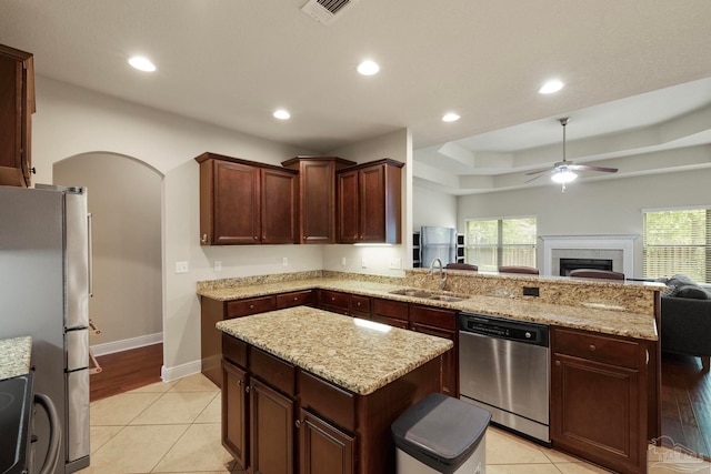 kitchen with a healthy amount of sunlight, sink, stainless steel appliances, and light hardwood / wood-style flooring