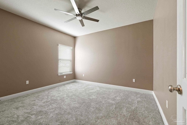 unfurnished room with ceiling fan, carpet floors, and a textured ceiling