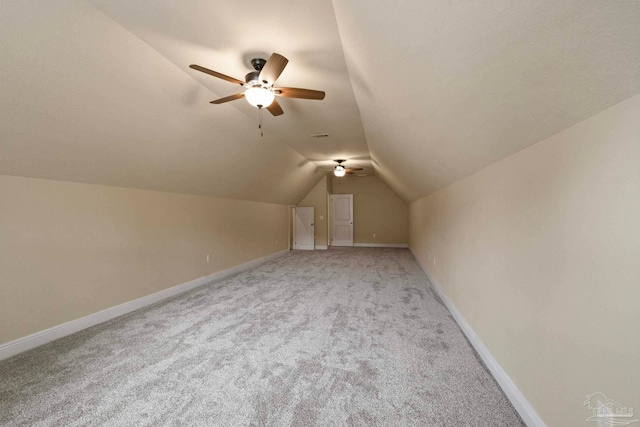 additional living space with ceiling fan, light carpet, and vaulted ceiling