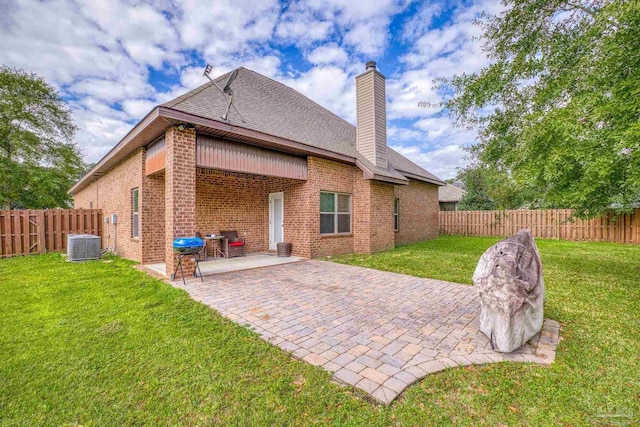 back of house with a lawn, a patio area, and central air condition unit