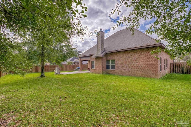 back of property featuring a yard and a patio