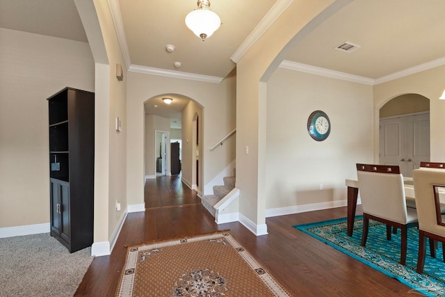 interior space with dark hardwood / wood-style flooring and ornamental molding