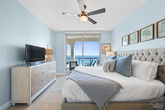 bedroom featuring ceiling fan, a wall of windows, baseboards, access to exterior, and light tile patterned floors