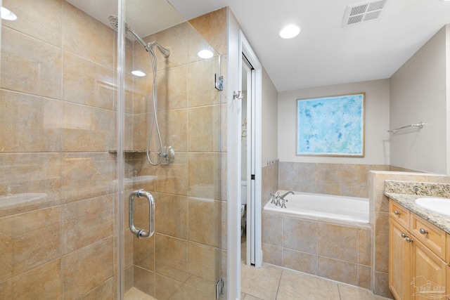 full bathroom featuring visible vents, toilet, a garden tub, a stall shower, and vanity