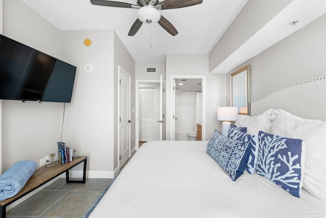 bedroom featuring ceiling fan, baseboards, visible vents, and connected bathroom