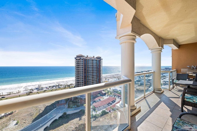 balcony with a beach view and a water view