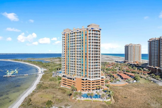 bird's eye view featuring a water view, a view of city, and a beach view