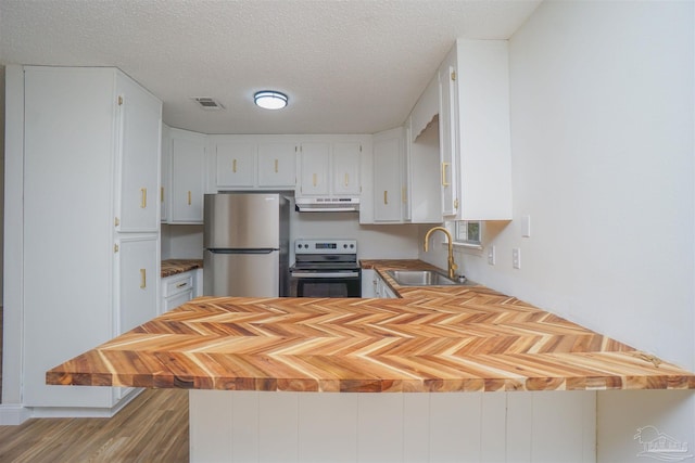 kitchen with white cabinets, light hardwood / wood-style floors, sink, and stainless steel appliances