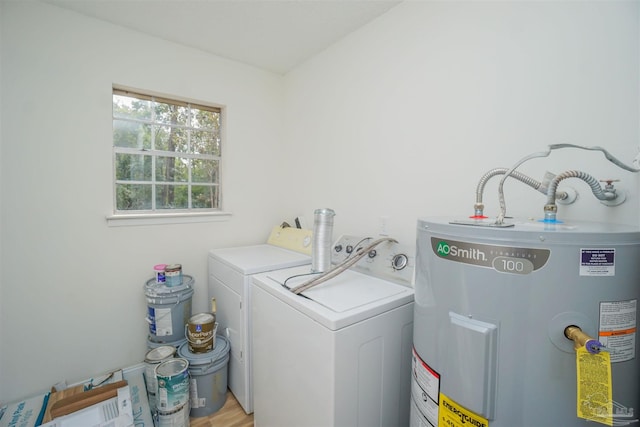 laundry room featuring light hardwood / wood-style floors, electric water heater, and separate washer and dryer