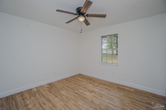 spare room featuring hardwood / wood-style flooring, ceiling fan, and a textured ceiling