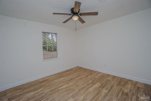 unfurnished room with ceiling fan, light hardwood / wood-style floors, and a textured ceiling